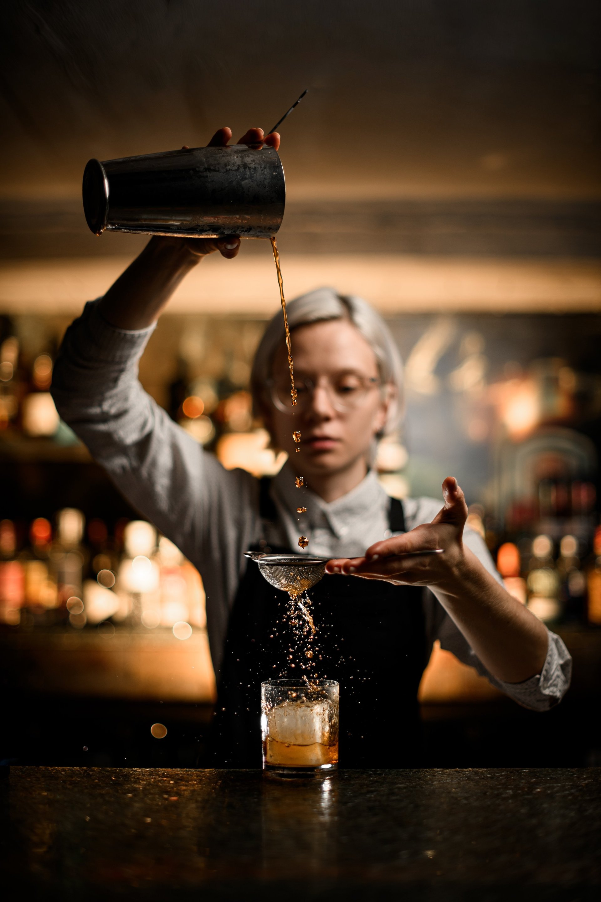 Bartender pouring cocktail